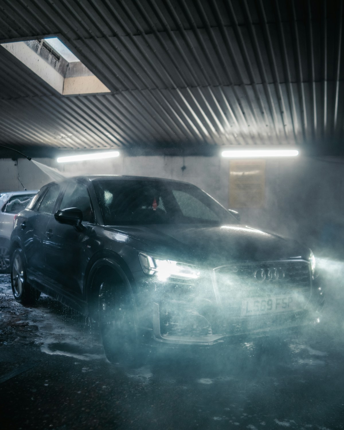 A vehicle inside a professional car wash
